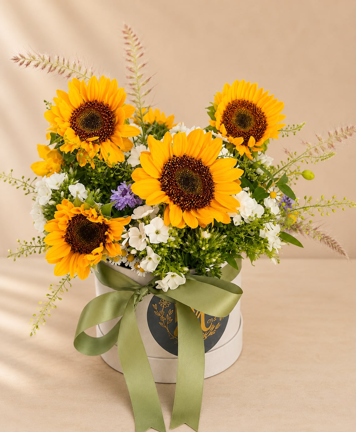 Hand-tied hat box of flowers by Willow and Moss