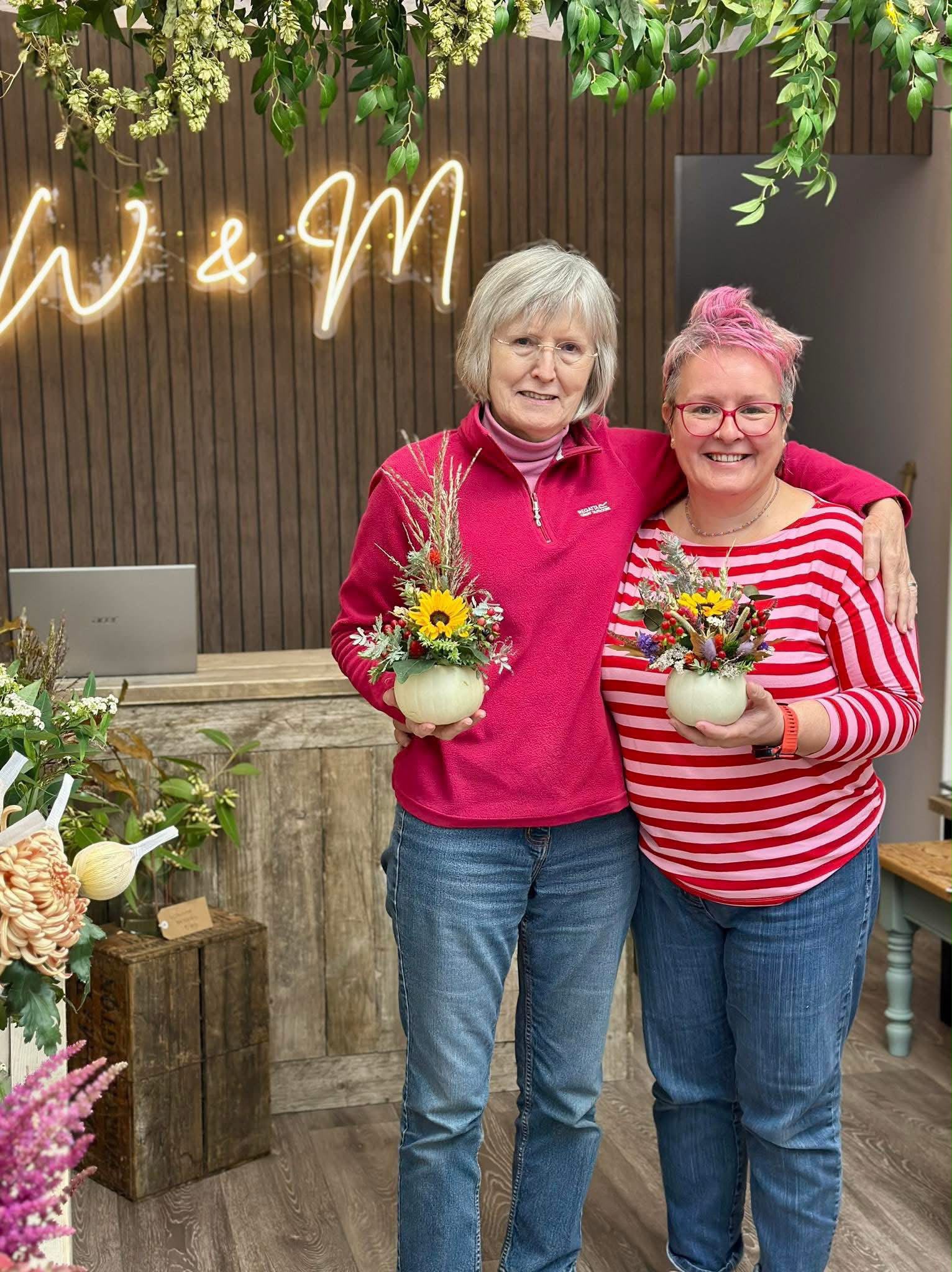 Guests arranging flowers at a Willow and Moss workshop