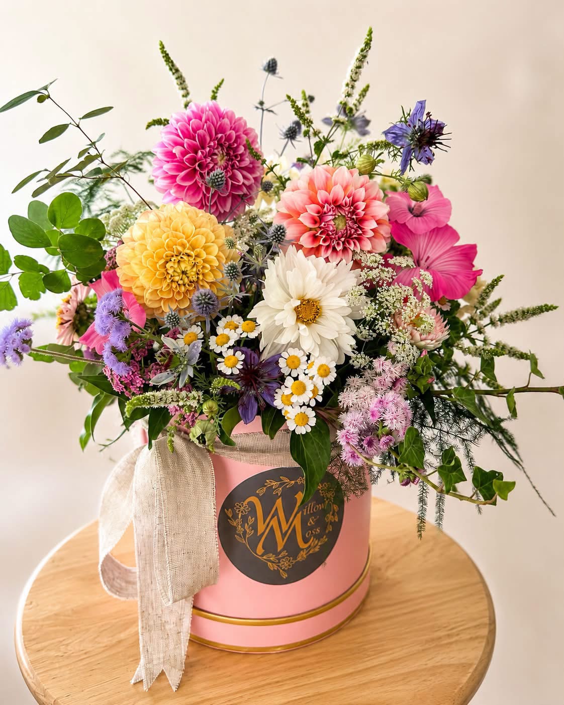 Flowers arranged in a hat box by Willow and Moss